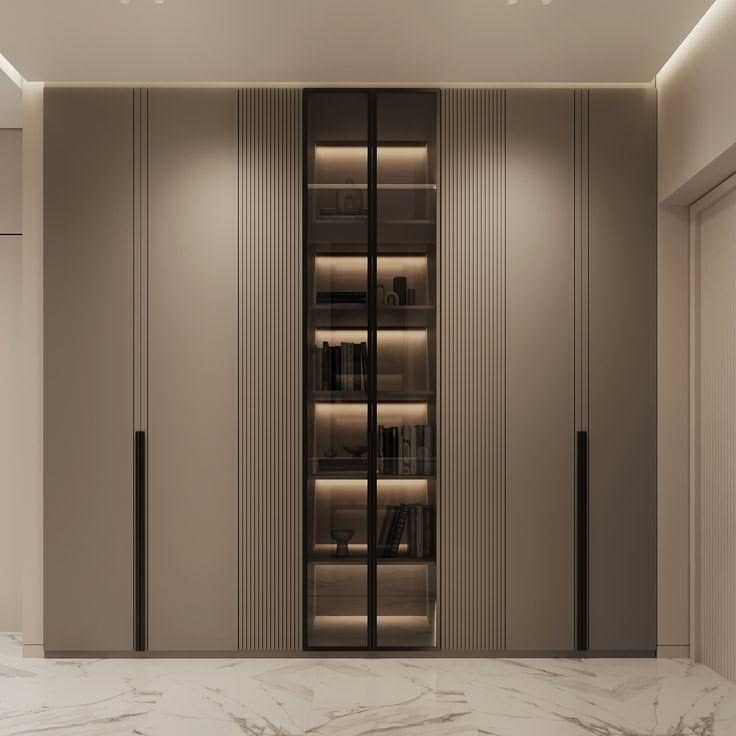 Floor-to-ceiling cabinetry with a lit glass display section
