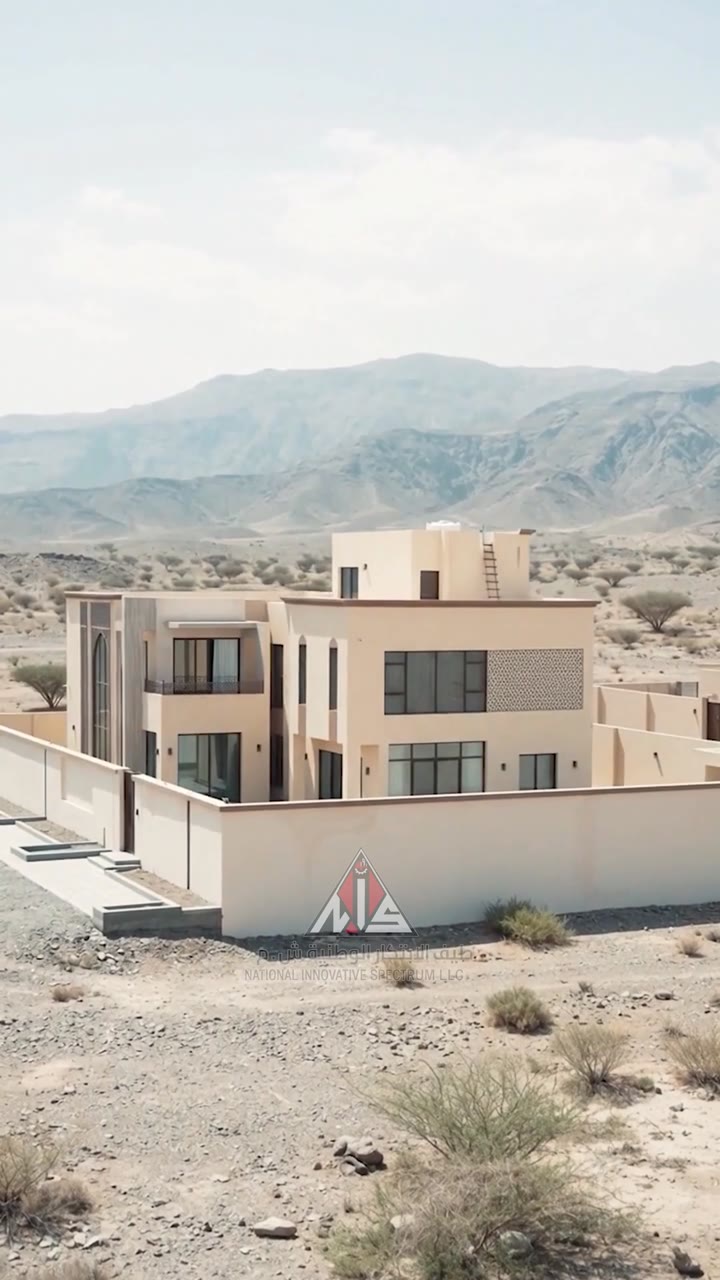 Villa in Nizwa seen from a distance with mountains behind