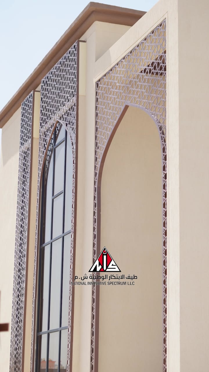 Two-storey facade with lattice screens and arched openings, Nizwa