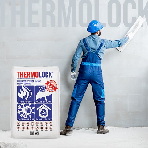 Worker applying Thermolock plaster to a wall with a trowel